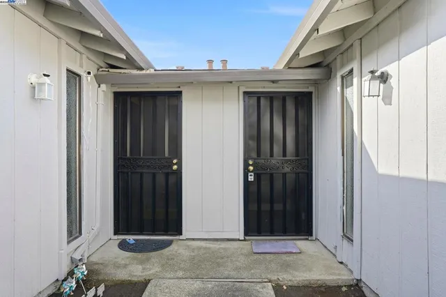 an empty room with wooden floor and fireplace