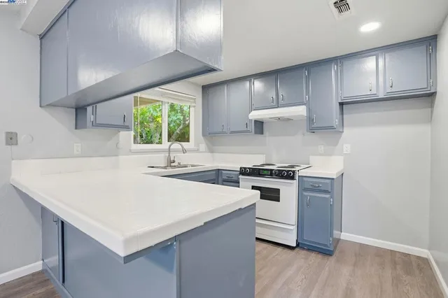 a kitchen with a sink stainless steel appliances and cabinets