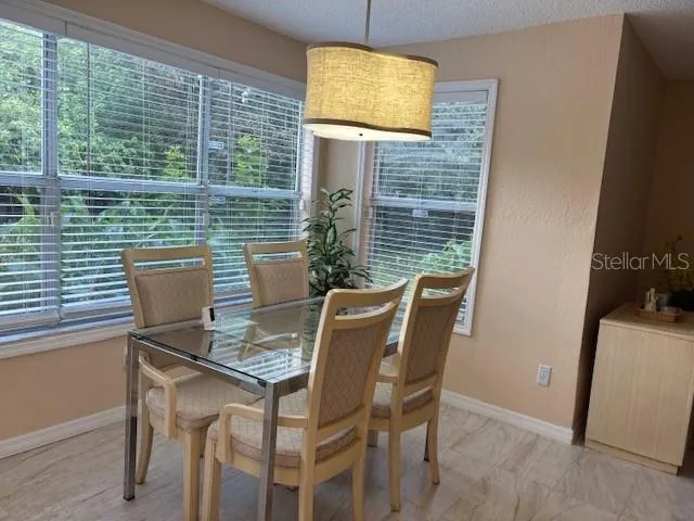 a view of a dining room with furniture and a window
