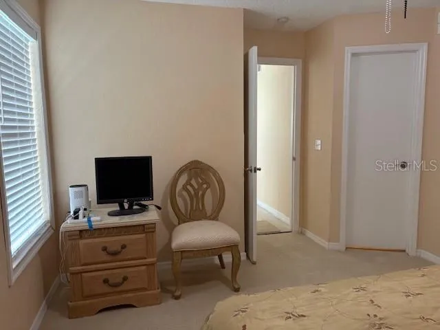 a view of a workspace with furniture and a window