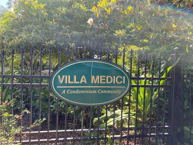 a sign that is sitting on a brick wall