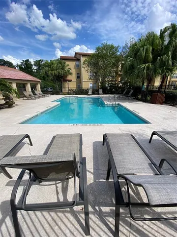 a view of outdoor space with lounge chairs