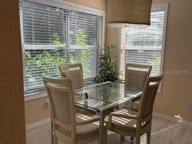 a view of a dining room with furniture and window