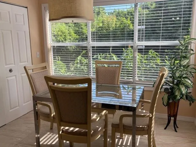 a view of a dining room with furniture and window