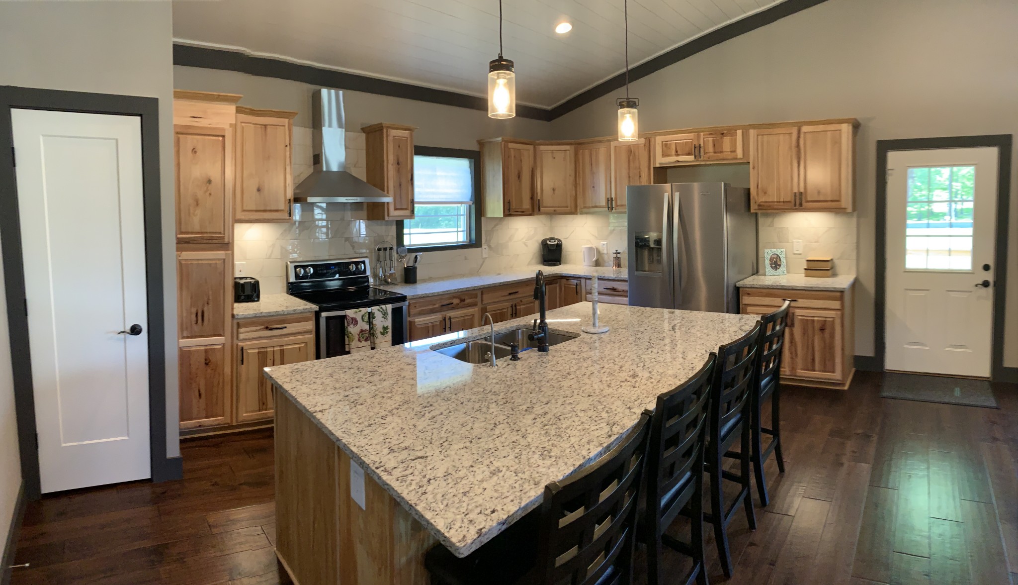 580 Pruett Road Dickson, TN 37055 - Photo 25 of 46 a kitchen with granite countertop a table chairs stove and refrigerator