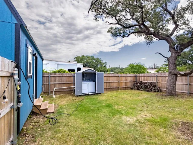 a view of a backyard with swimming pool