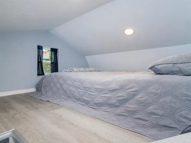 a bedroom with a bed and window