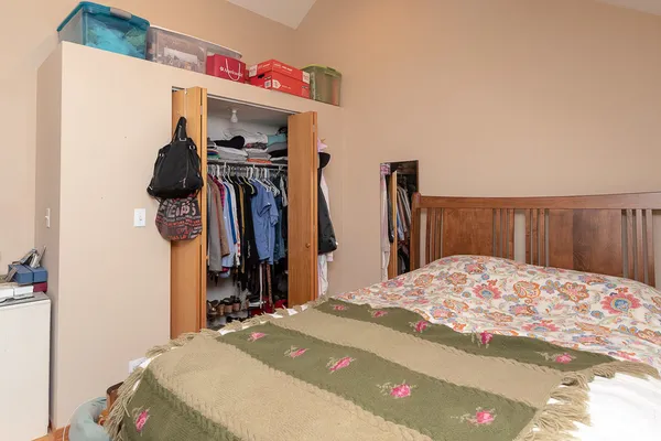 a bedroom with a bed and a closet