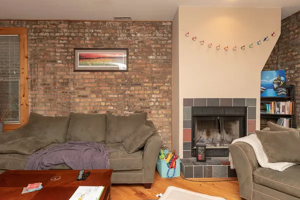 a view of living room kitchen with furniture and fireplace