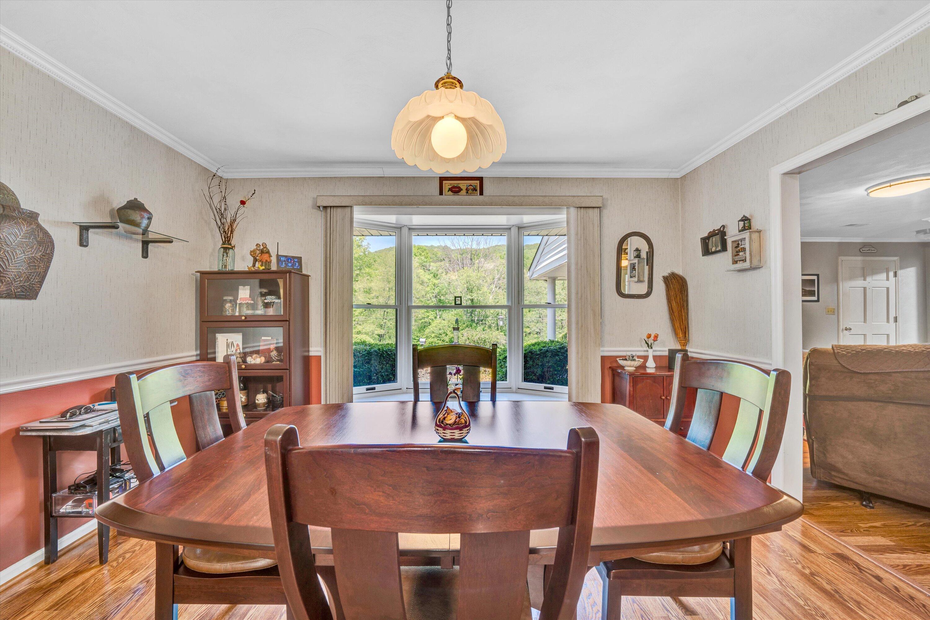 1033 Annie Bell Road Blue Ridge, VA 24064 - Photo 15 of 46 a view of a dining room with furniture window and outside view