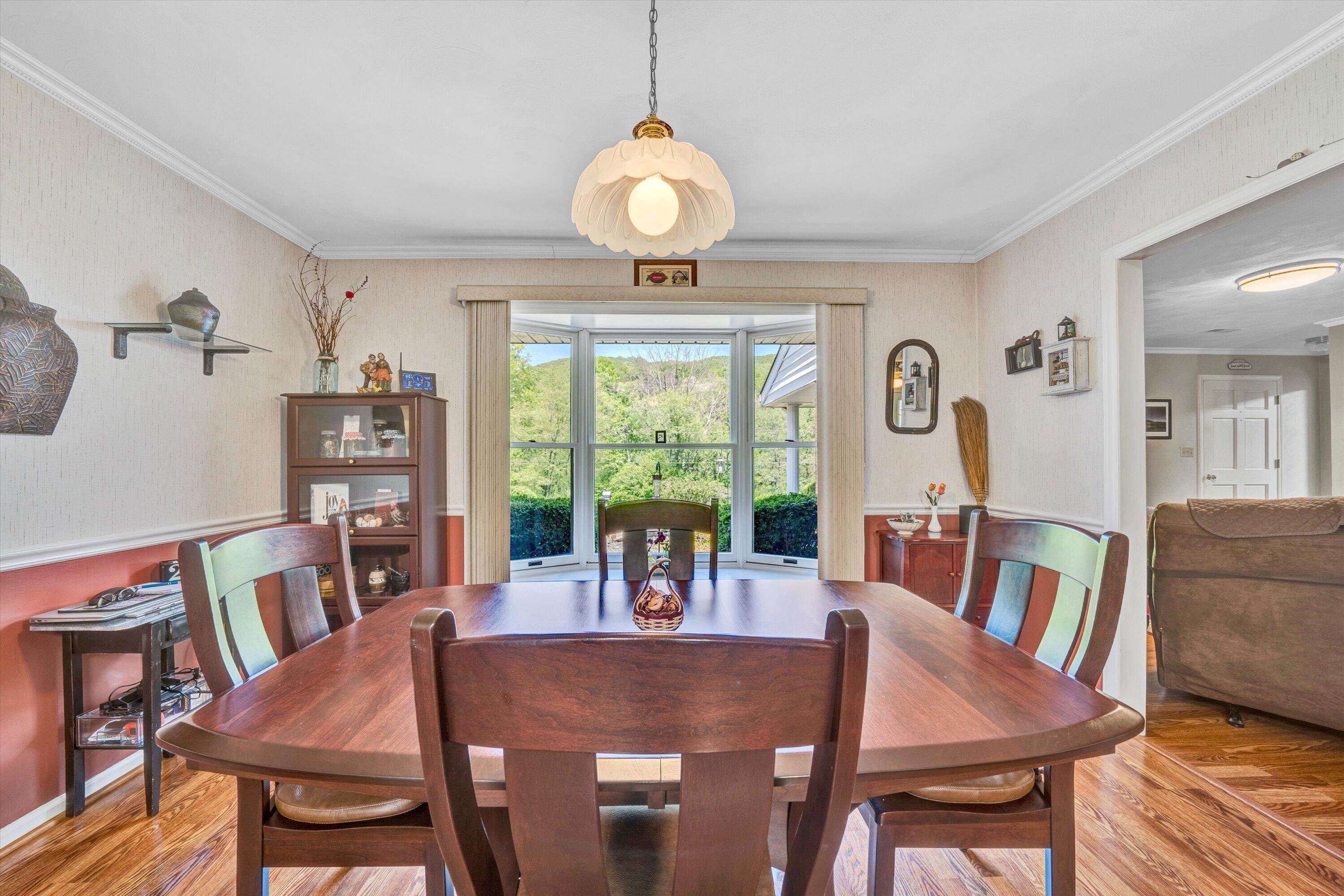 1033 Annie Bell Road Blue Ridge, VA 24064 - Photo 16 of 46 a view of a dining room with furniture window and wooden floor