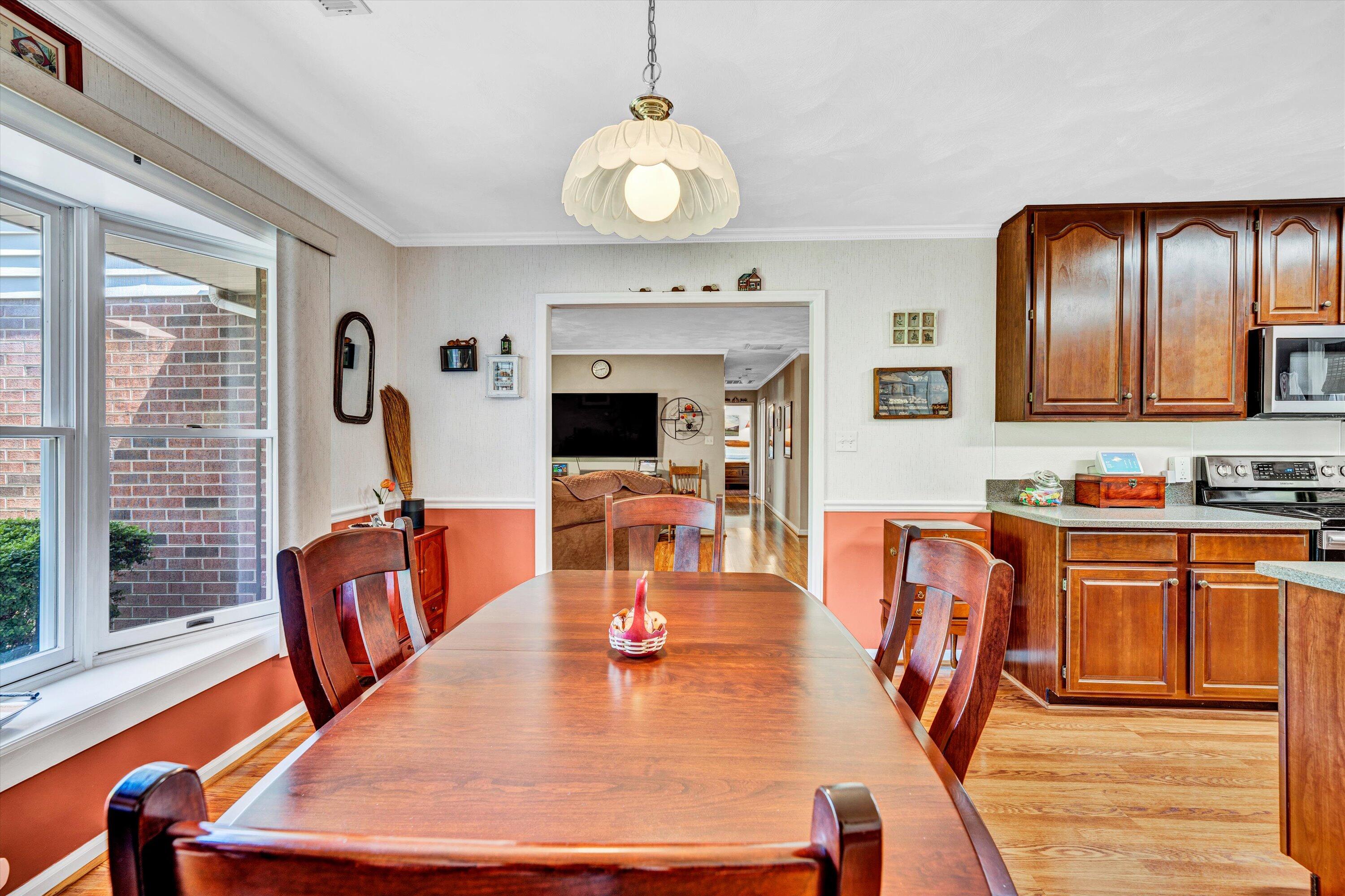 1033 Annie Bell Road Blue Ridge, VA 24064 - Photo 19 of 46 a view of a dining room with furniture a chandelier and wooden floor