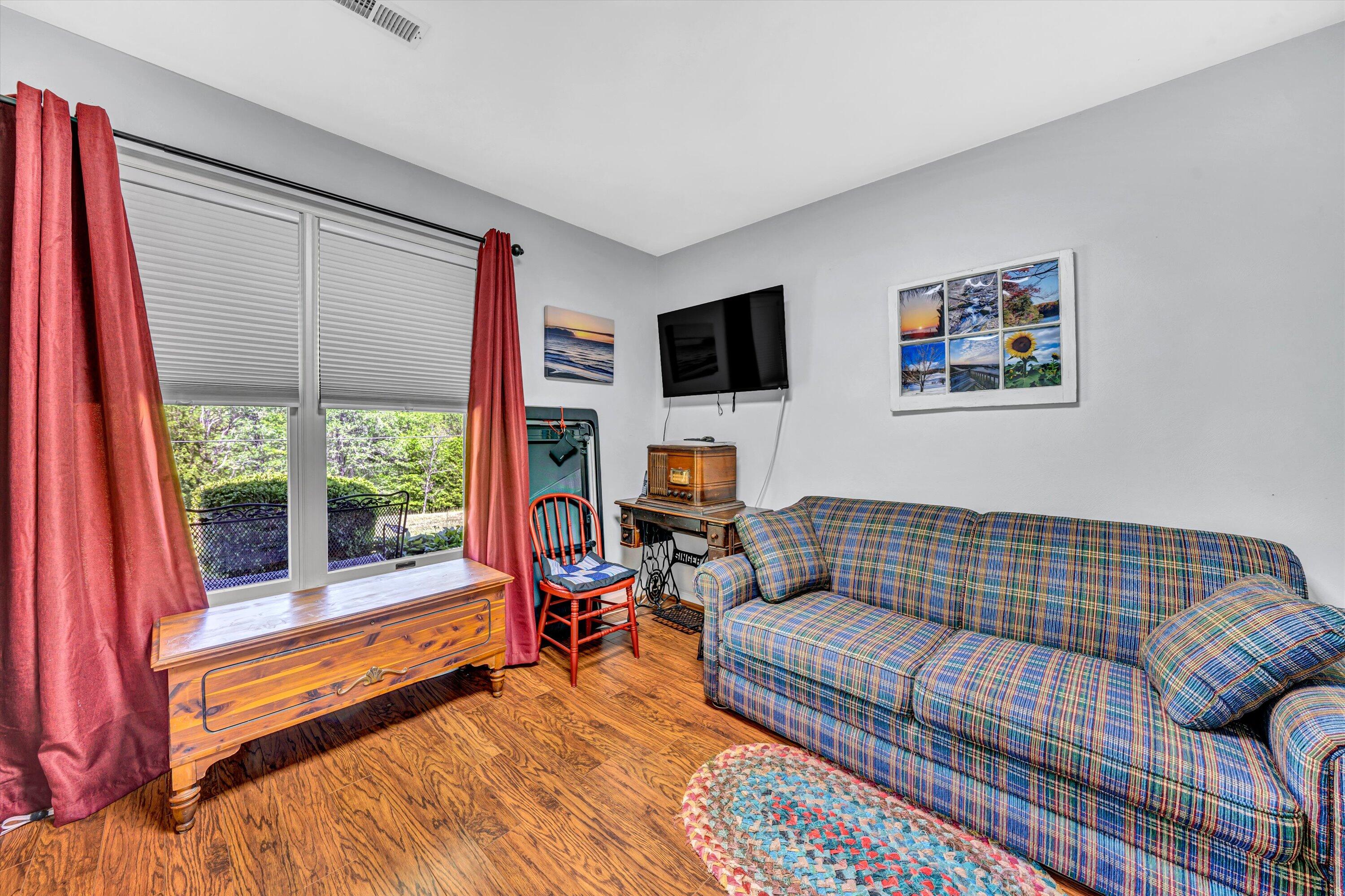 1033 Annie Bell Road Blue Ridge, VA 24064 - Photo 23 of 46 a living room with furniture and a flat screen tv
