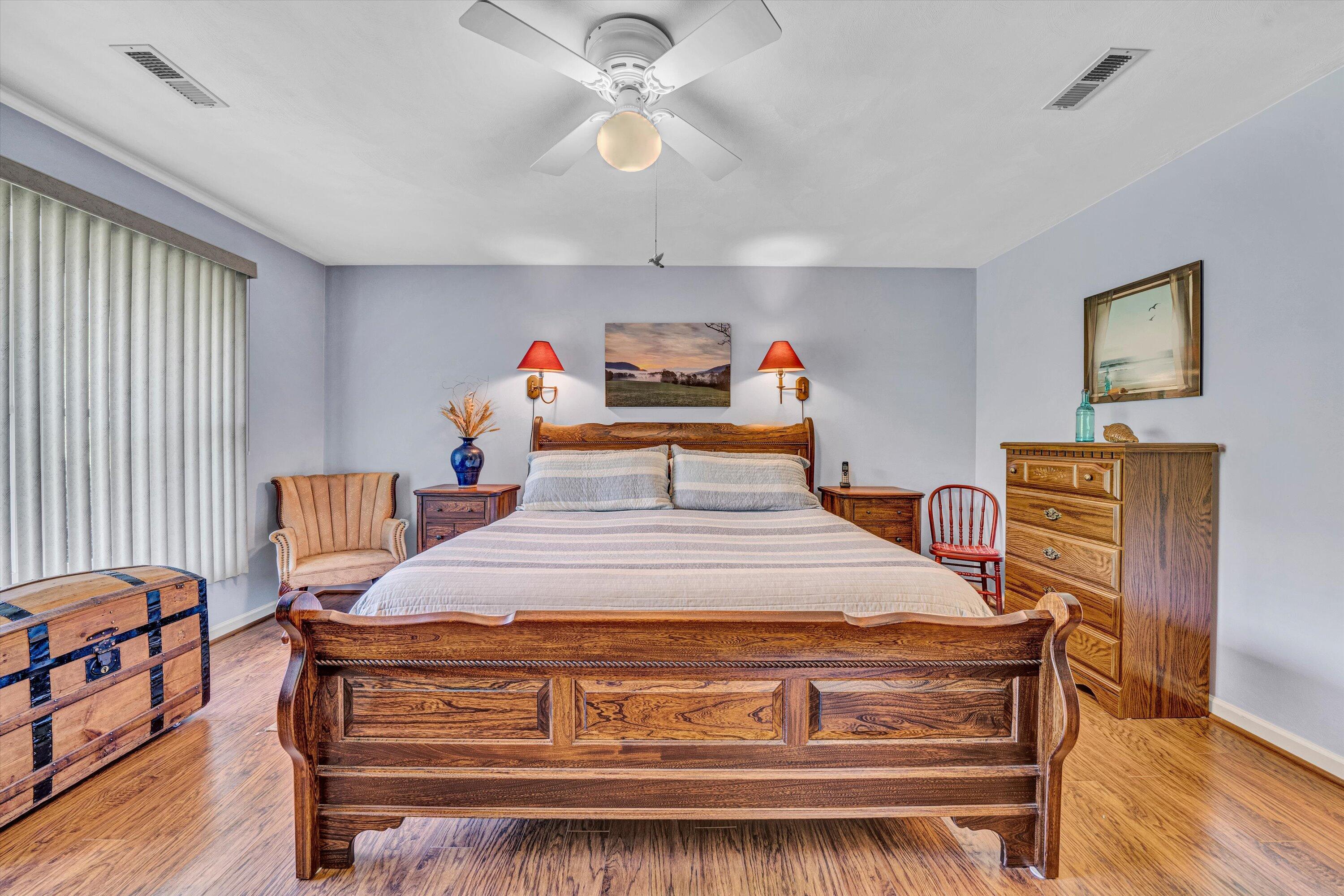 1033 Annie Bell Road Blue Ridge, VA 24064 - Photo 27 of 46 a bed room with a bed and a chandelier
