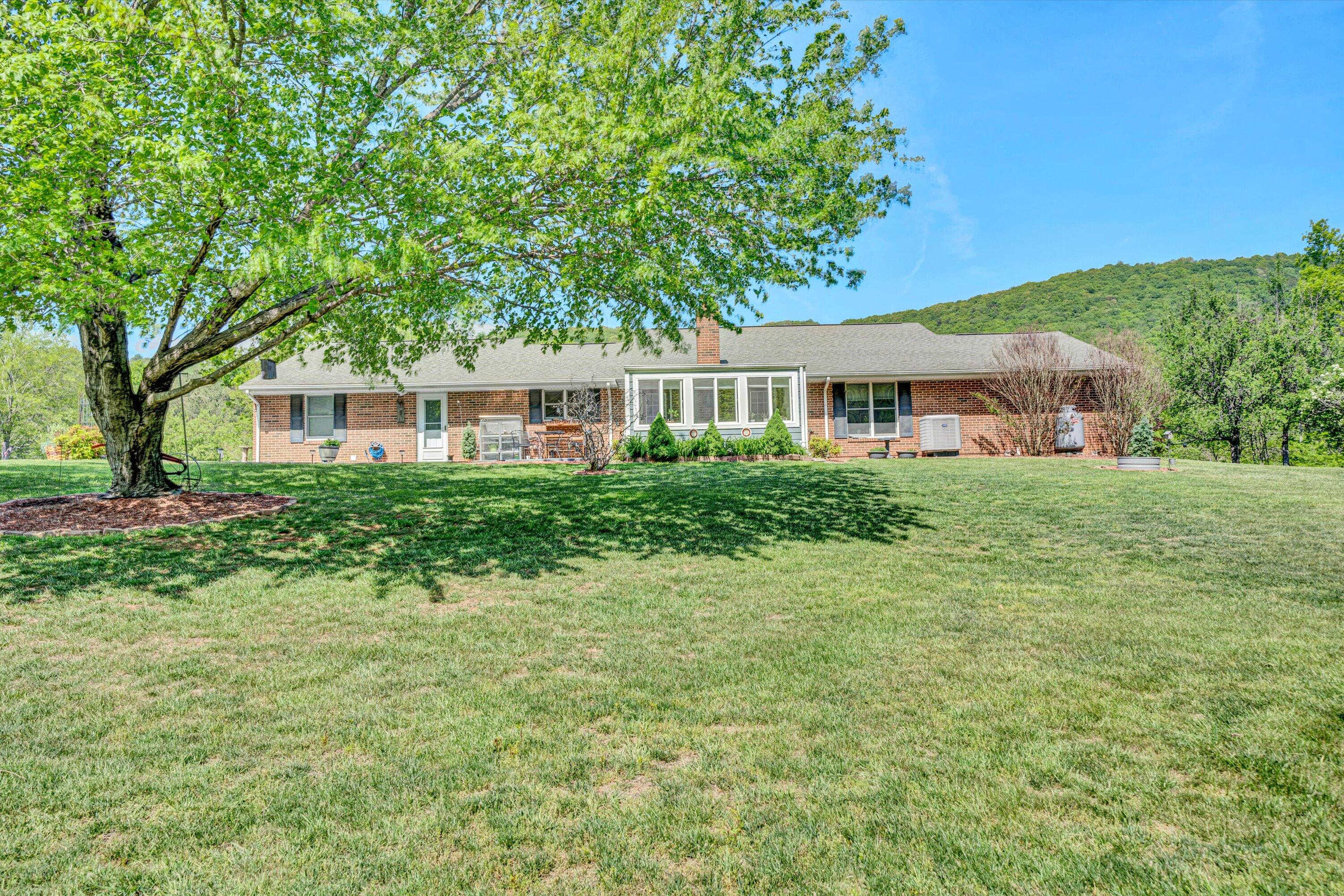 1033 Annie Bell Road Blue Ridge, VA 24064 - Photo 38 of 46 a front view of a house with a yard