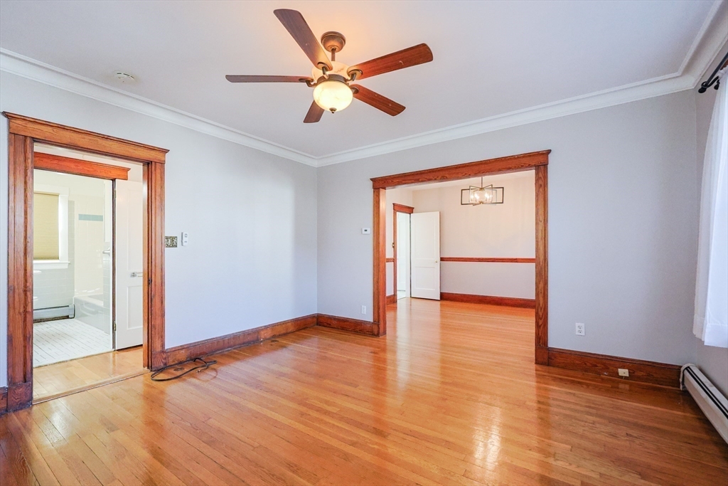 55 Glenellen Road Boston, MA 02132 - Photo 20 of 41 an empty room with wooden floor and a ceiling fan
