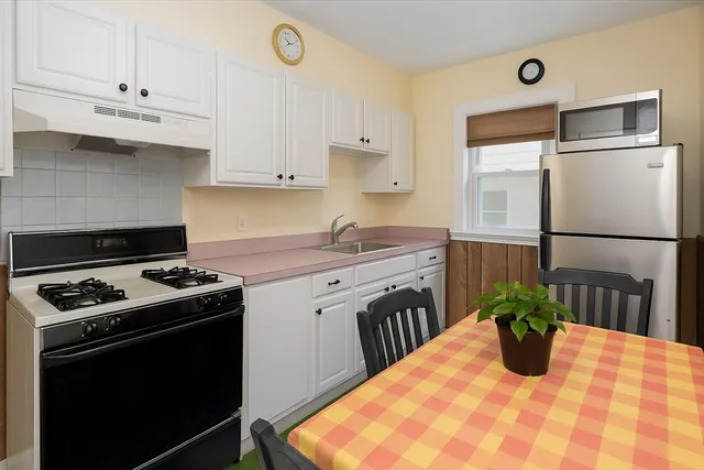 a kitchen with stainless steel appliances granite countertop a stove a sink dishwasher and a refrigerator