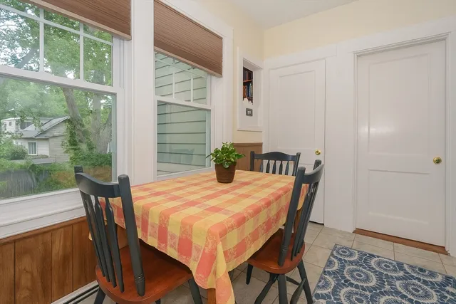 a dining room with furniture and wooden floor