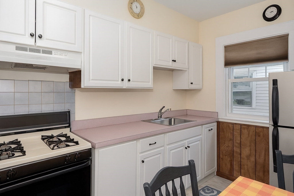 55 Glenellen Road Boston, MA 02132 - Photo 10 of 41 a kitchen with granite countertop a stove sink and cabinets