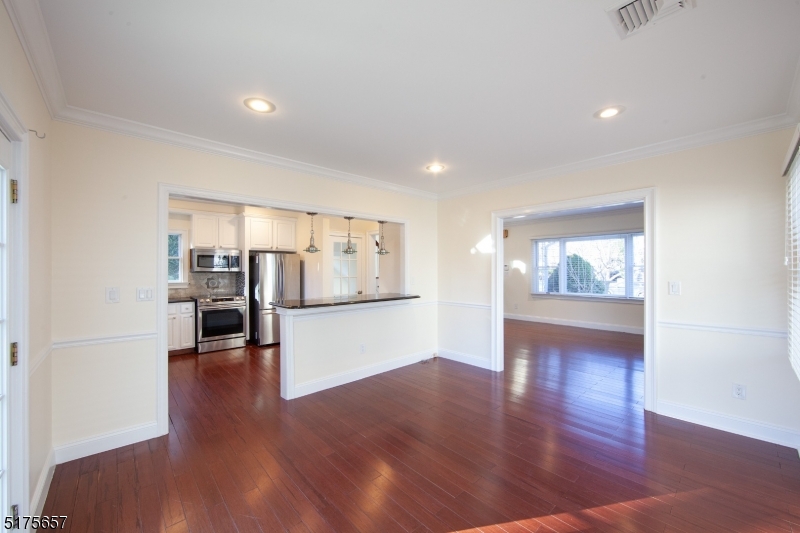 16 Columbus Avenue Glen Ridge, NJ 07028 - Photo 12 of 14 a view of a big room with wooden floor and windows