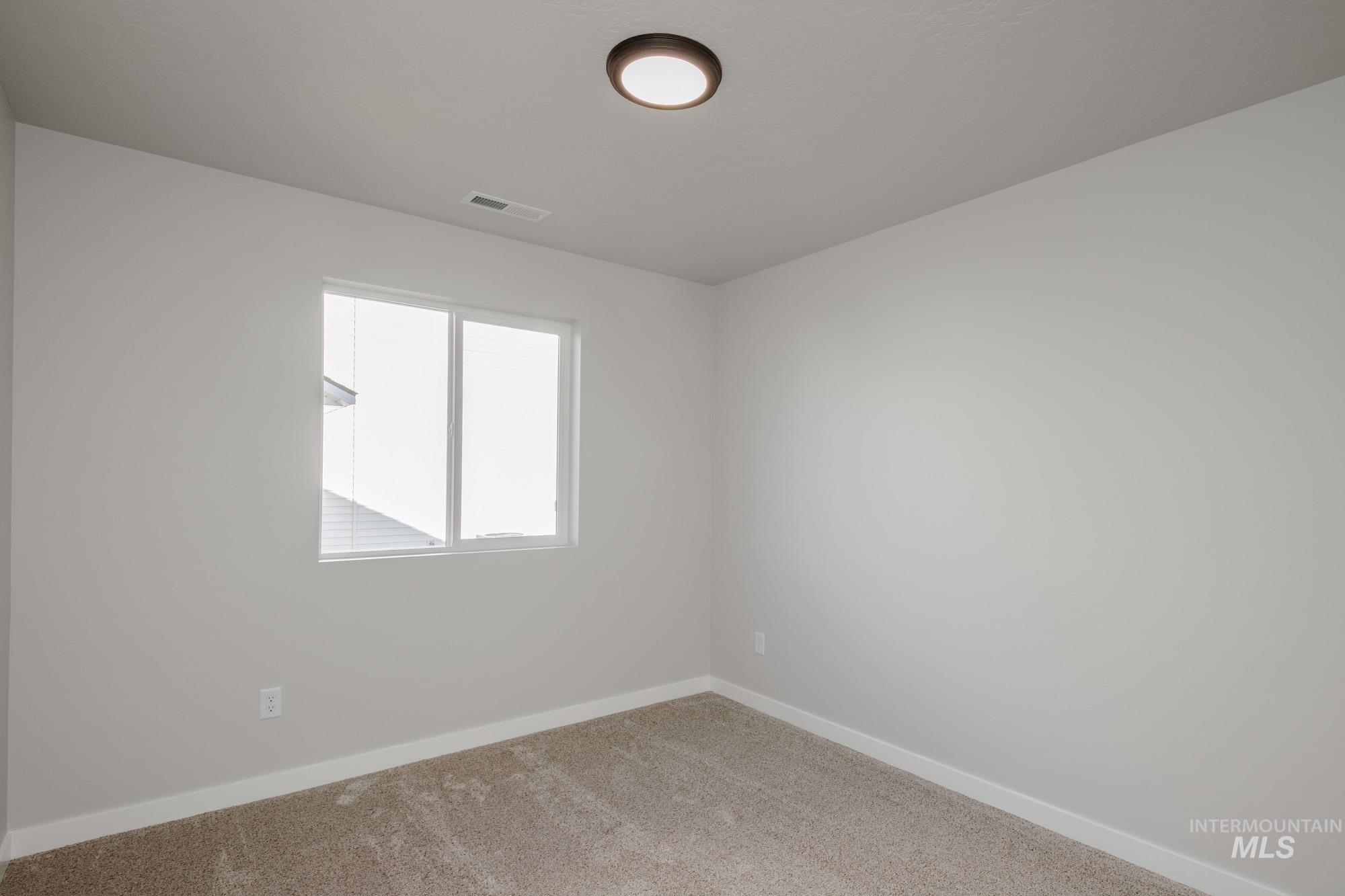 3290 South Maple Rnch Way Nampa, ID 83686 - Photo 10 of 20 Carpeted empty room featuring baseboards