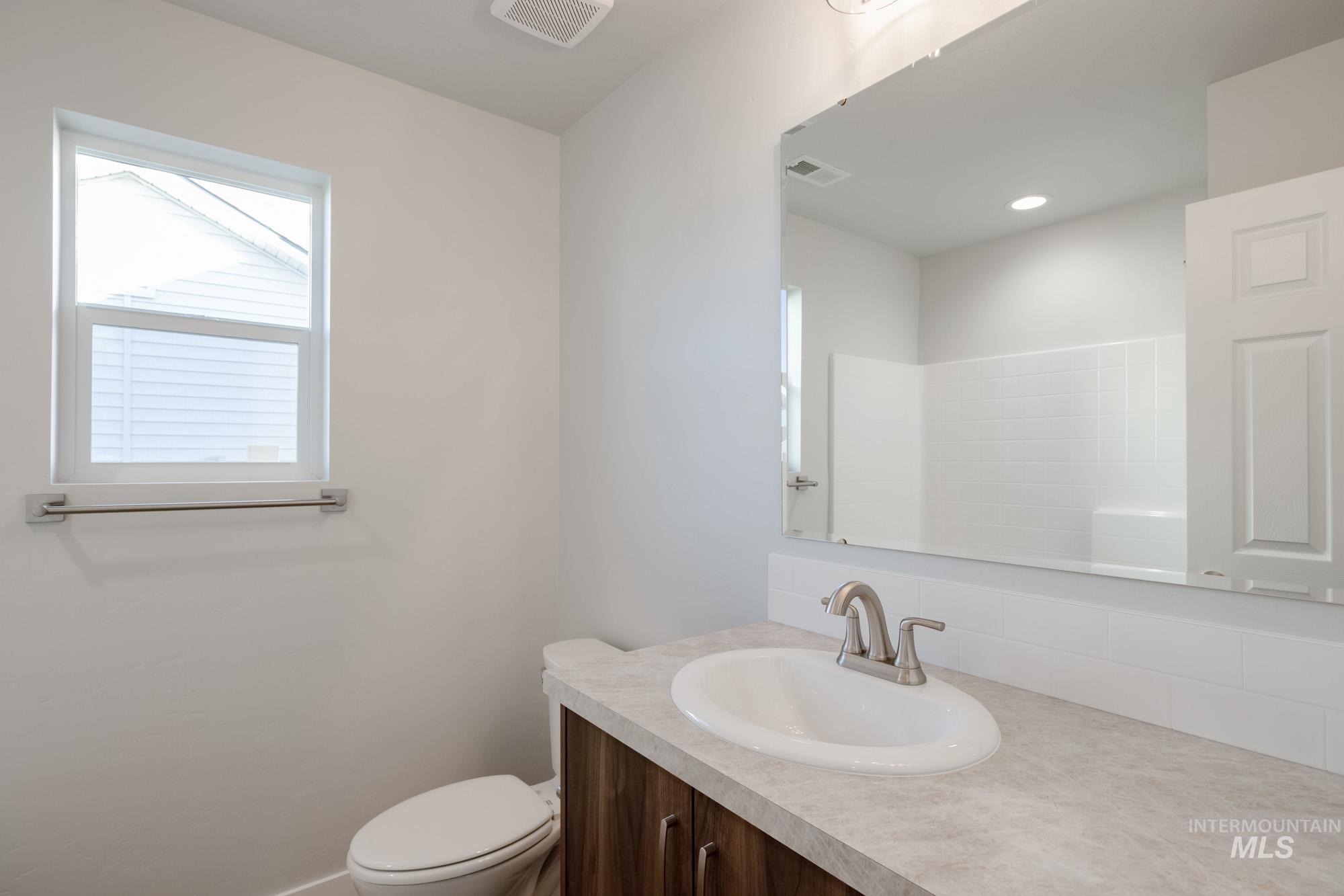 3290 South Maple Rnch Way Nampa, ID 83686 - Photo 13 of 20 Bathroom with vanity and backsplash