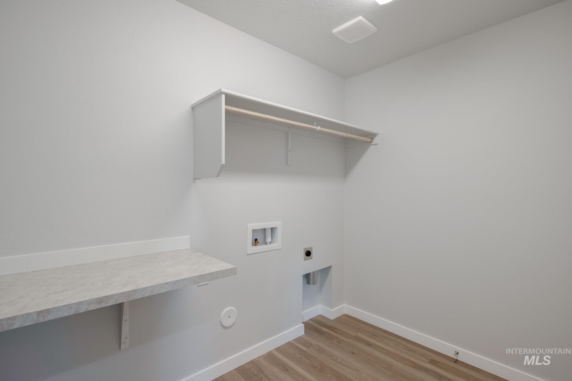 3290 South Maple Rnch Way Nampa, ID 83686 - Photo 17 of 20 Laundry area featuring light wood-style floors, hookup for a washing machine, and hookup for an electric dryer