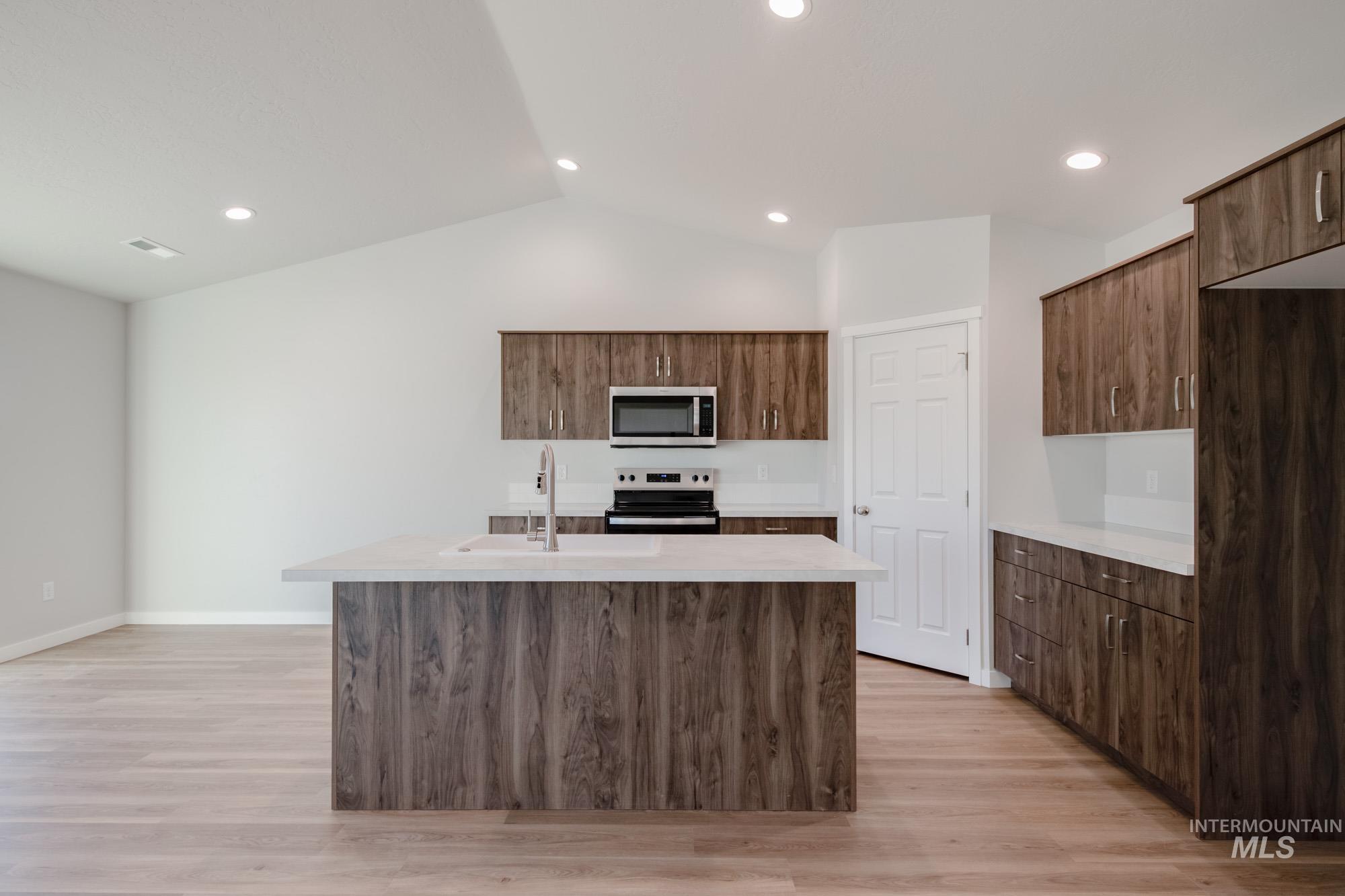 3290 South Maple Rnch Way Nampa, ID 83686 - Photo 8 of 20 Kitchen featuring a kitchen island with sink, stainless steel appliances, light wood-style flooring, modern cabinets, and recessed lighting