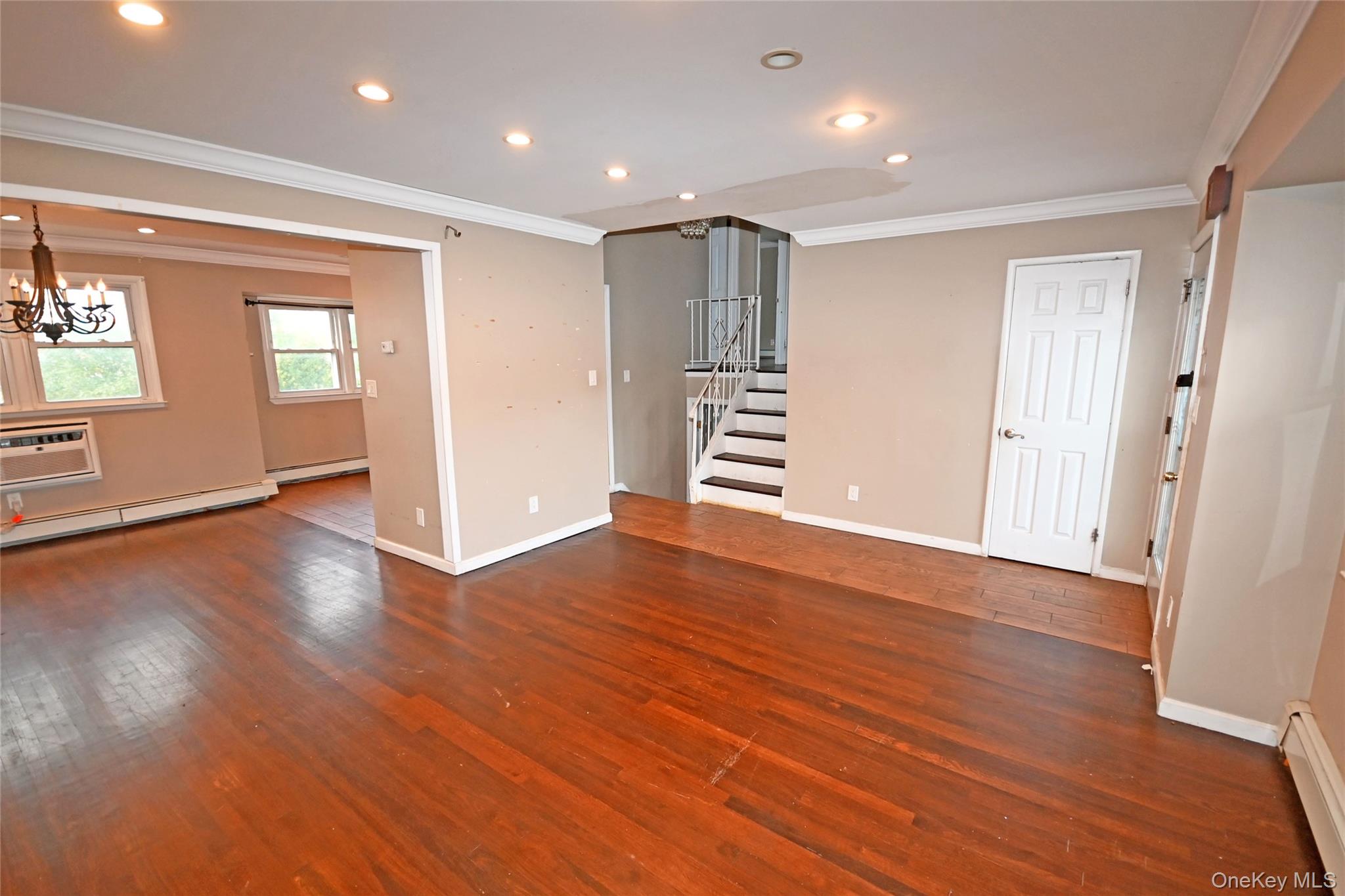 89 Osborne Road West Hempstead, NY 11552 - Photo 29 of 50 Unfurnished room with ornamental molding, a wall mounted AC, recessed lighting, dark wood-style floors, and baseboard heating