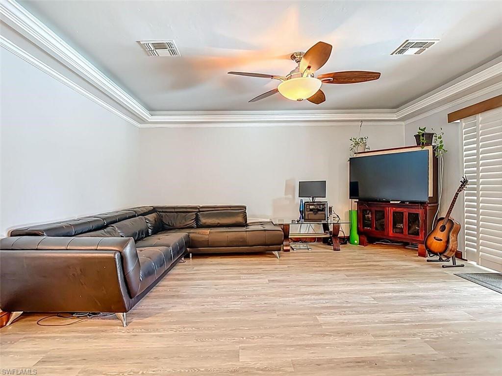 14991 Savannah Drive Naples, FL 34119 - Photo 14 of 50 a living room with furniture and a flat screen tv