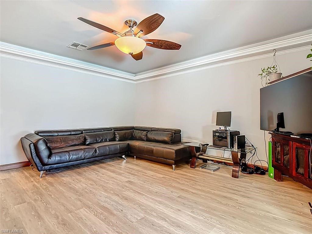 14991 Savannah Drive Naples, FL 34119 - Photo 15 of 50 a living room with furniture and a flat screen tv