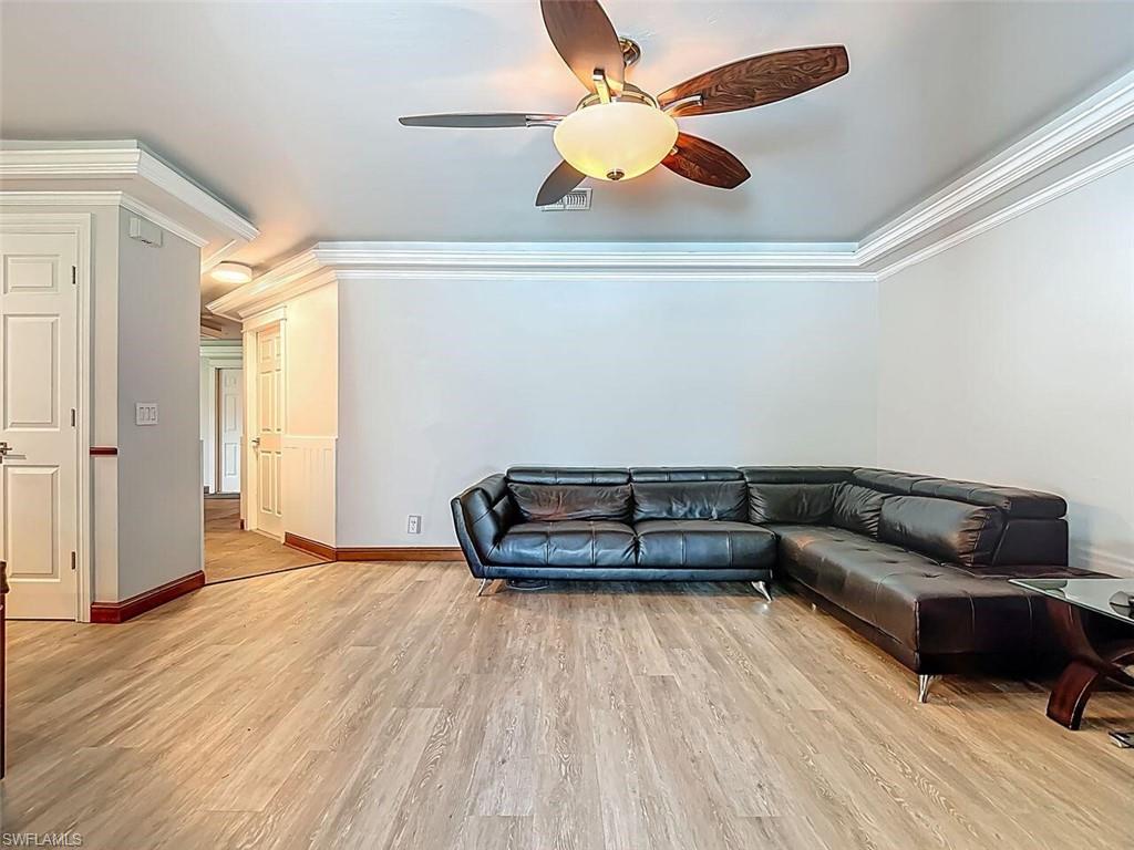 14991 Savannah Drive Naples, FL 34119 - Photo 16 of 50 a living room with furniture and a ceiling fan