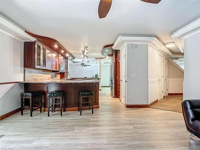 a view of living room and kitchen with furniture and wooden floor