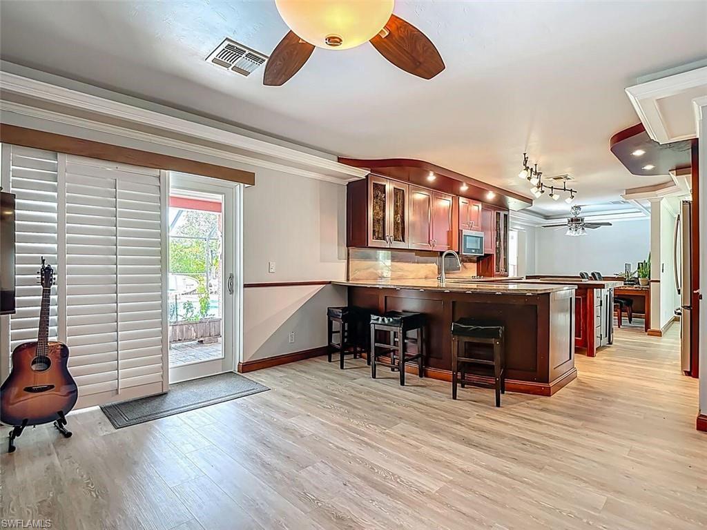 14991 Savannah Drive Naples, FL 34119 - Photo 18 of 50 a living room with furniture and a wooden floor