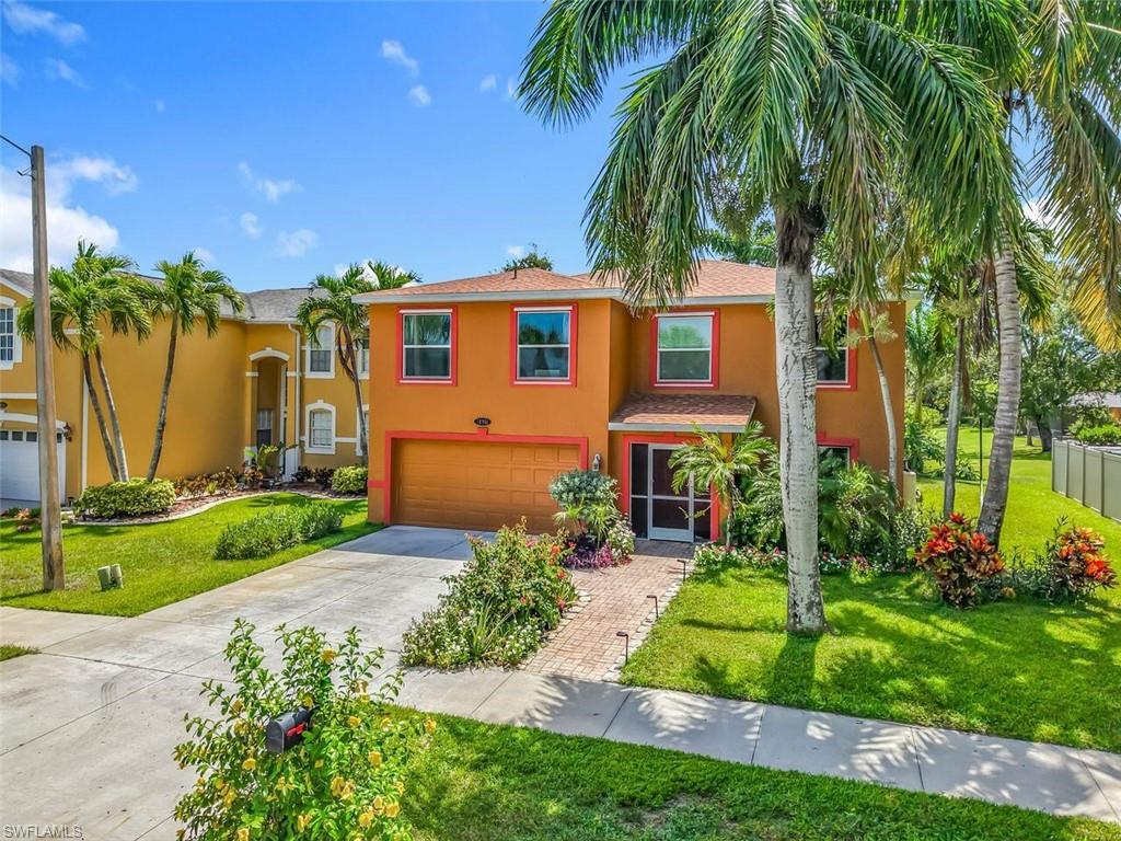 14991 Savannah Drive Naples, FL 34119 - Photo 2 of 50 a front view of a house with a garden