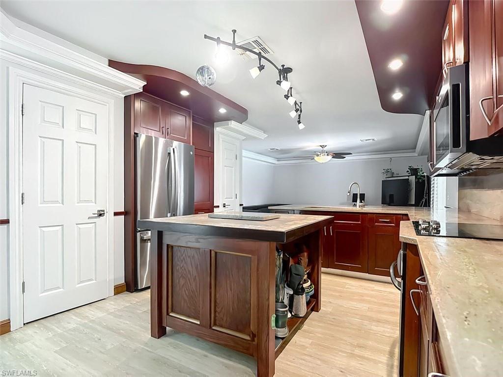 14991 Savannah Drive Naples, FL 34119 - Photo 21 of 50 a view of a kitchen island wooden floor