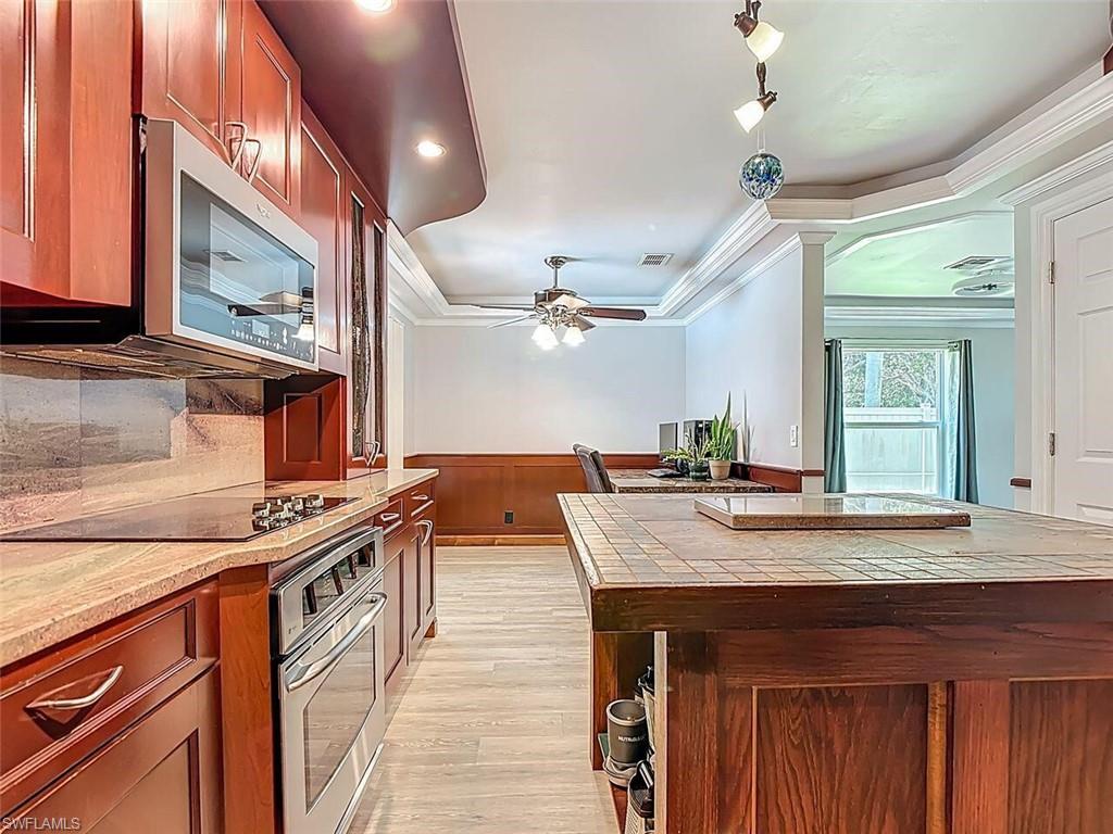 14991 Savannah Drive Naples, FL 34119 - Photo 24 of 50 a kitchen with stainless steel appliances granite countertop a stove and a sink