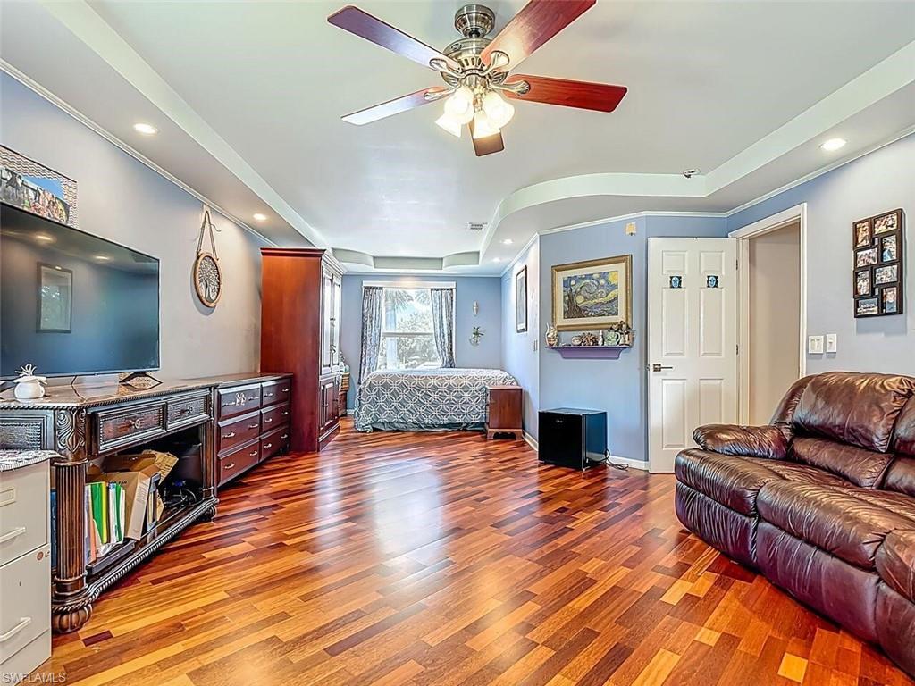14991 Savannah Drive Naples, FL 34119 - Photo 29 of 50 a living room with fireplace furniture and a flat screen tv