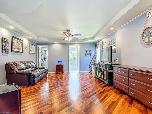a living room with couches and furniture with wooden floor