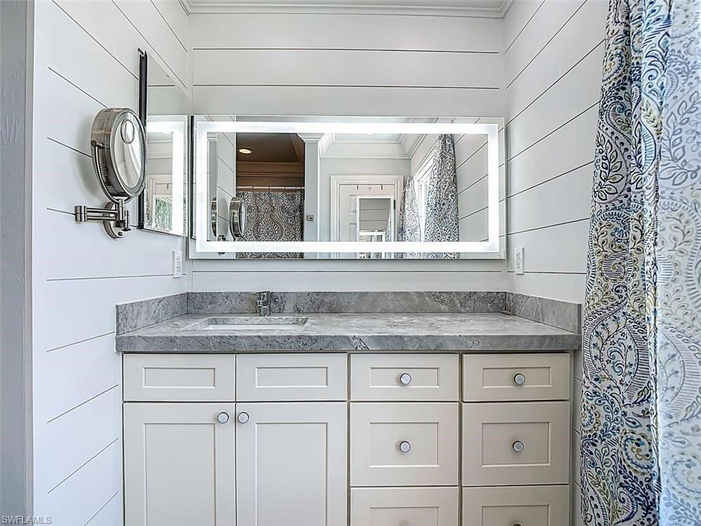 14991 Savannah Drive Naples, FL 34119 - Photo 34 of 50 a bathroom with a granite countertop sink and mirror