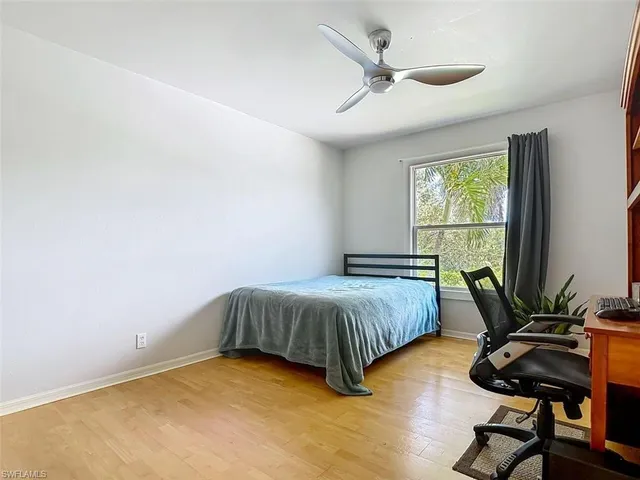 a bedroom with a bed and a potted plant