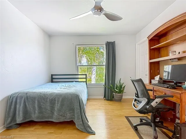 a bedroom with bed and a window