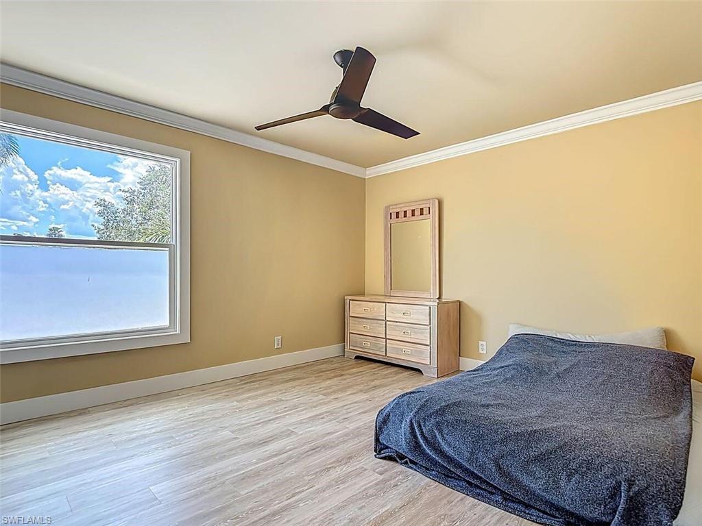 14991 Savannah Drive Naples, FL 34119 - Photo 39 of 50 a bedroom with a bed and wooden floor