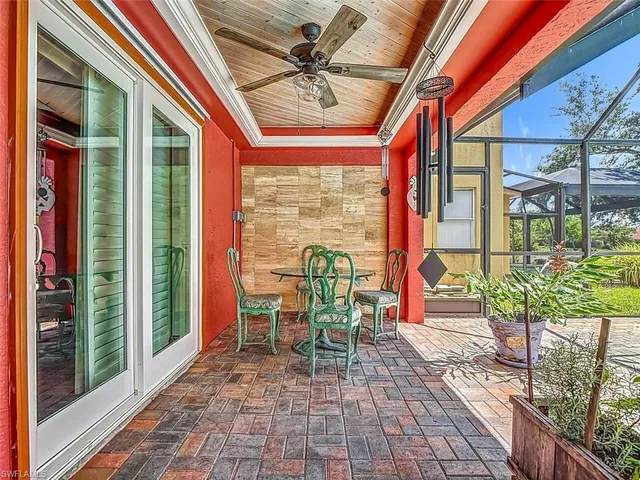 a porch area with a table and chairs