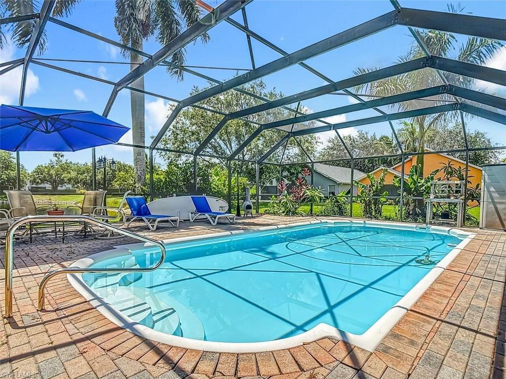 14991 Savannah Drive Naples, FL 34119 - Photo 48 of 50 a view of a swimming pool with a patio