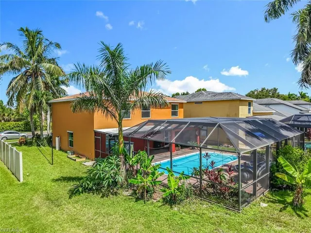 a patio with table and chairs under an umbrella