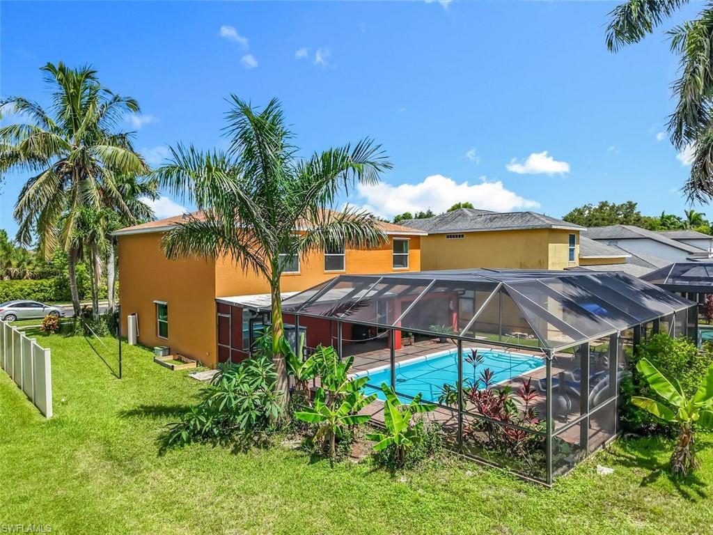 14991 Savannah Drive Naples, FL 34119 - Photo 50 of 50 a patio with table and chairs under an umbrella