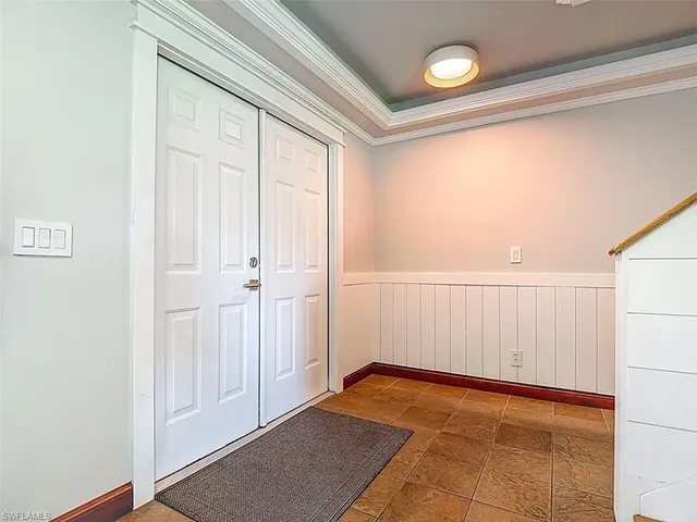 a view of a room with an empty space and a window