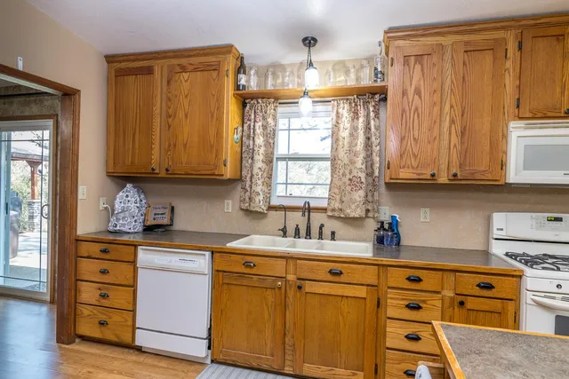 a kitchen with a sink appliances and cabinets