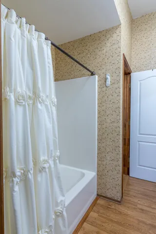a bathroom with a granite countertop toilet sink and mirror